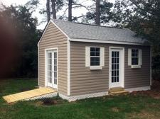 12x16 Gable shed with 7/12 roof pitch, ramp, lattice skirting, window and vinyl siding